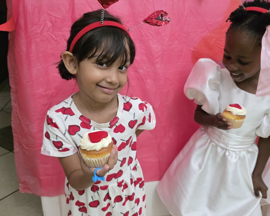 Two children sharing cupcakes at Little Toddlers Creche